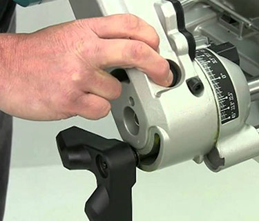unlocking the base of a miter saw