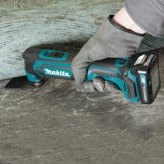 A hand working with Makita MT01R1
