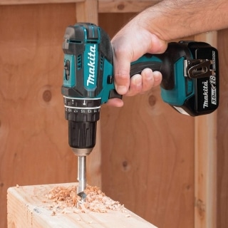 Man working with Makita XPH10Z hammer drill