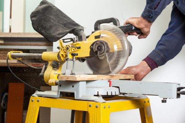 After you’ve decided between a sliding vs compound miter saw, consider whether you need a dual or single compound — that is, if the blade arm tilts to either one or two sides.  If you go for a single model — you’ll need to flip and turn the wood to create an opposite angle. And, if like me, your brain doesn’t work in mirror mode, this can lead to mistakes — meaning you end up making the cut in the wrong direction. While not a major issue, it can mean additional expense as you have to throw away the timber and start again.  Dual compounds are much more convenient, faster, and don’t require you to repetitively manhandle the lumber. Furthermore, for left-handers, they offer greater user equality, since the right-handed fascist single compound units discriminate against sinistrality (you’ve learned a new word — this article is both informative and educational).  But of course, nothing in life is free. Expect to pay around $50-$75 dollars more for a dual machine.
